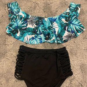 Green and blue greenery top, super high rise, black cheeky bottoms, two piece.